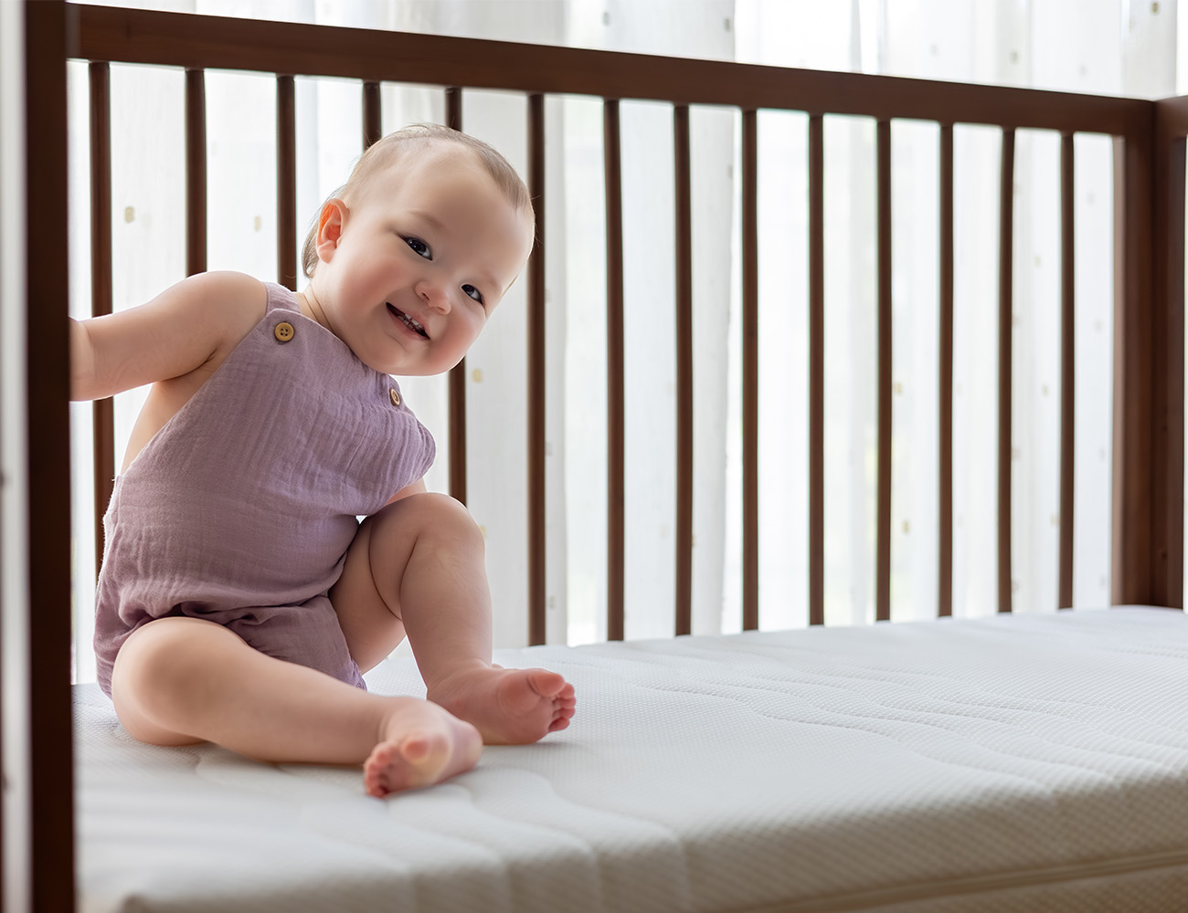 Happy baby welcoming you to join her on her Slumbear breathable mattress